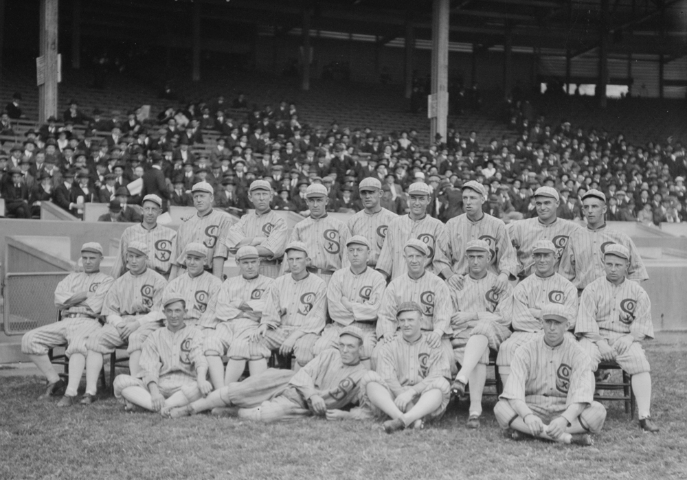 In 1913, the Reds lost a game to the Cubs, while wearing White Sox Uniforms.  The Reds' uniforms didn't make the trip, and the White Sox owner Comiskey  loaned the Reds his