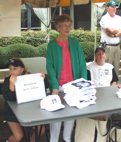 Kate Anders Selling Shirts and Hats